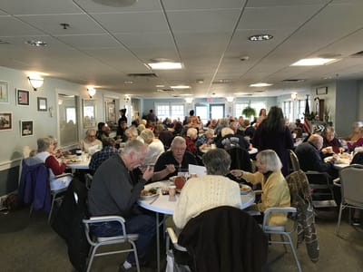Residents enjoying a meal in the dining room.