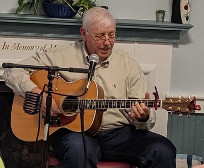 Resident playing guitar in a common area