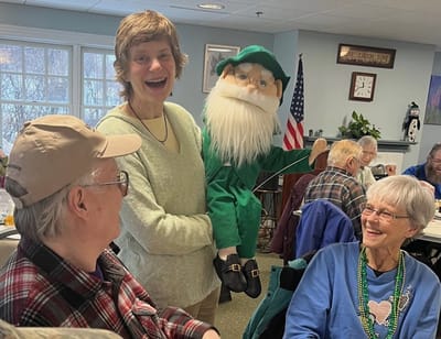 Residents enjoy a lighthearted moment with a puppet.