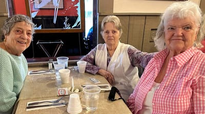 Three residents enjoying time together at a table