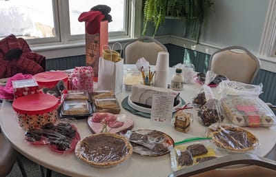 A table filled with assorted baked goods and refreshments.