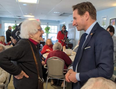 Resident and staff member engaged in conversation.