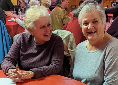 Two residents enjoying a conversation at a table