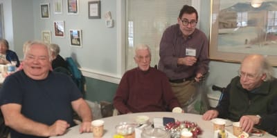 Four residents enjoying food in a common area