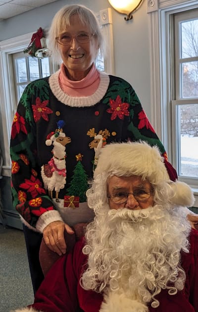 Resident with Santa during a holiday celebration.
