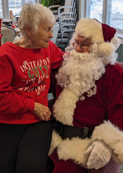 Resident enjoying time with Santa Claus