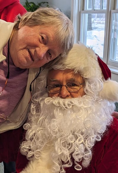 Resident posing with Santa Claus