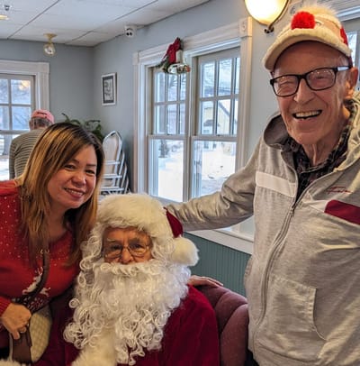 Residents celebrating with Santa during a holiday event