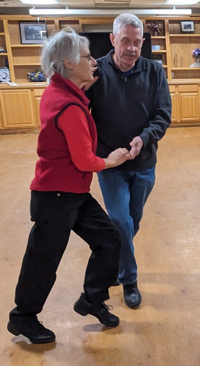 Residents dancing in a community hall.