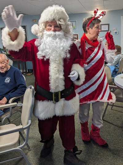 Residents celebrating with Santa Claus and holiday-themed costumes.