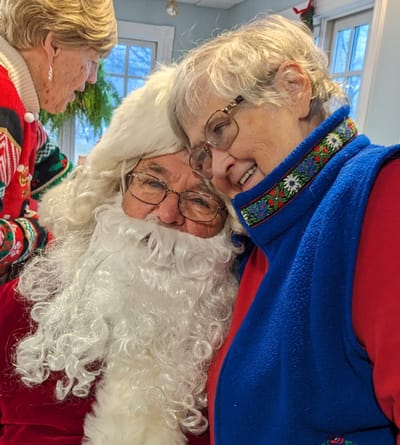 Resident joyfully interacting with Santa Claus.