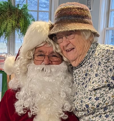 Resident with Santa Claus during a festive event.
