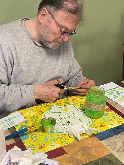 Resident engaged in a creative activity at a table