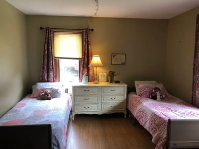 Private resident room with two beds and decor