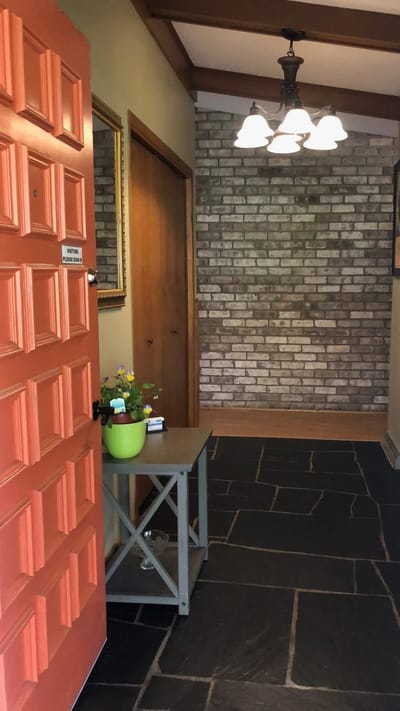 Interior view of an entryway with an orange door