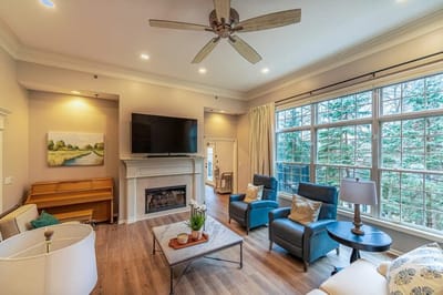 Bright common area with seating and large windows