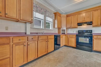 Spacious kitchen with wooden cabinets and appliances