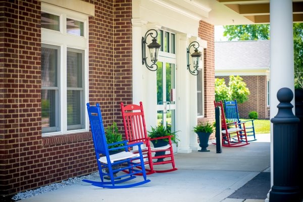 Colorful rocking chairs on a porch