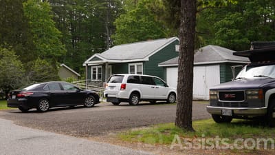 Vehicles parked outside a green building