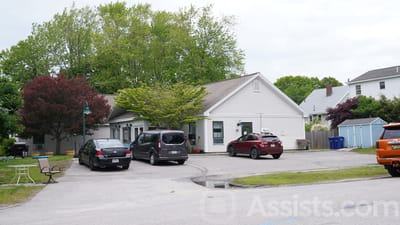 Exterior view of a senior care facility with parking area