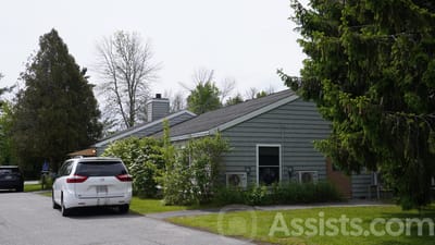 Exterior view of Pride House facility surrounded by greenery