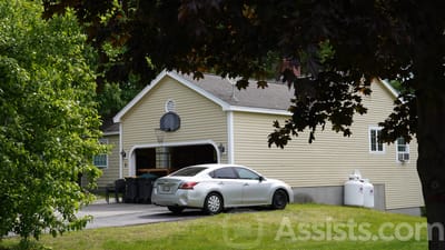 Exterior of a senior living facility with vehicle