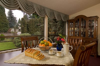 Dining table set with food and flowers.