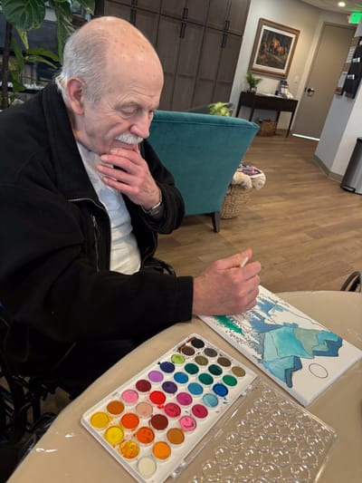 Resident painting in a common area.