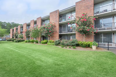 Exterior view of the facility with flowering shrubs.