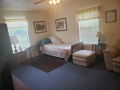 Cozy interior room with a bed and seating area.