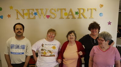 Residents smiling in a common area at New Start Inc.