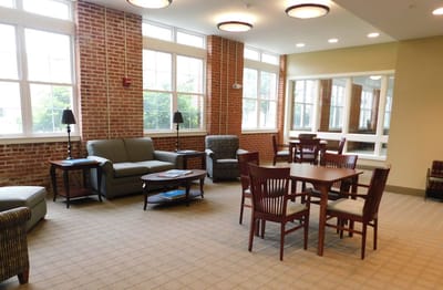 Bright common area with seating and tables