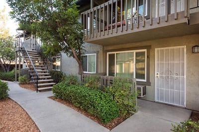 Exterior view of a multi-story building with landscaping.