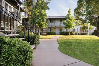 Well-maintained gardens and pathways outside residences.