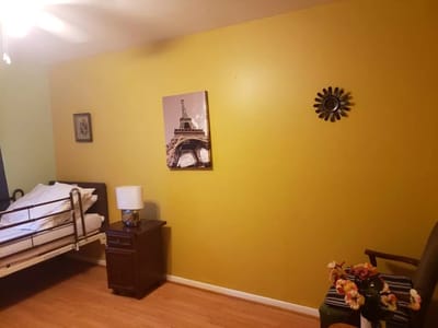 Private resident room with yellow walls and decor.