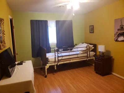 Private bedroom with a hospital bed and air-conditioning