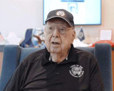 Senior resident speaking in a common area.