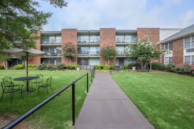 Outdoor area with seating and brick building.