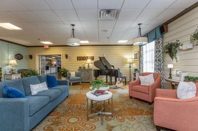 Welcoming common area with seating and a piano.