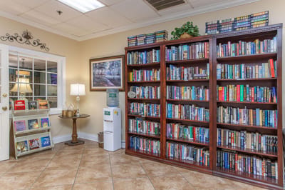 Cozy common area with bookshelves and decor.