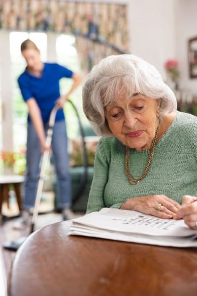 Resident engaged in an activity with staff assistance.