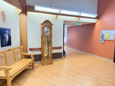 Interior hallway with clock and seating