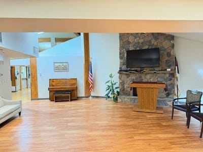 Spacious common area with seating and television.