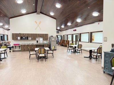 Bright common area with tables and chairs.