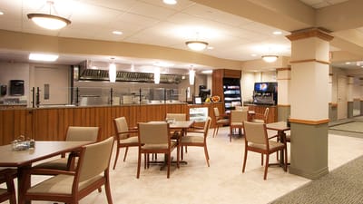 Dining area with tables and chairs in a common space.