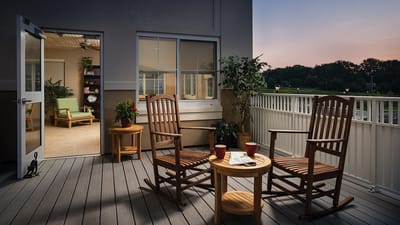 Cozy outdoor balcony with rocking chairs and plants