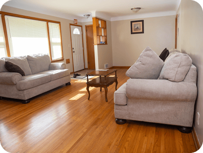 Cozy living room with two sofas and a wooden table.