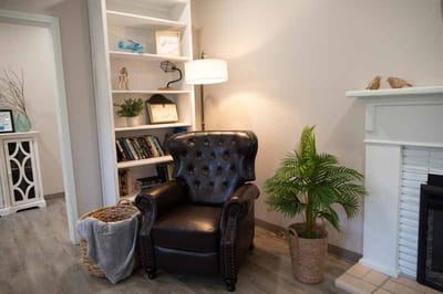 Cozy seating area with a leather chair and lamp