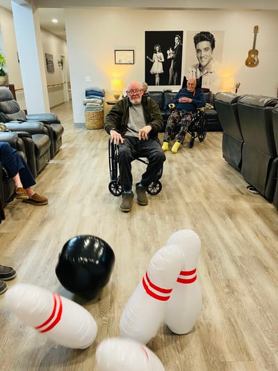 Seniors enjoying a bowling activity indoors.