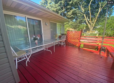 Outdoor patio space with seating and greenery.